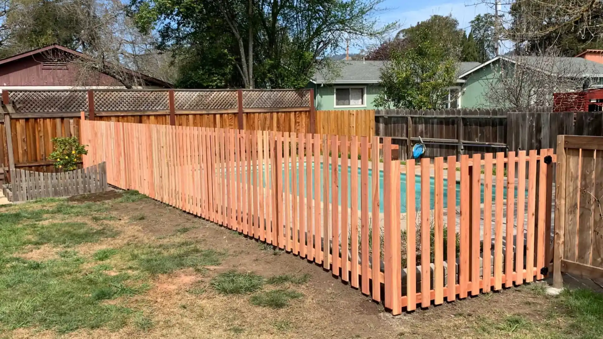 picket fence with pool within the fence