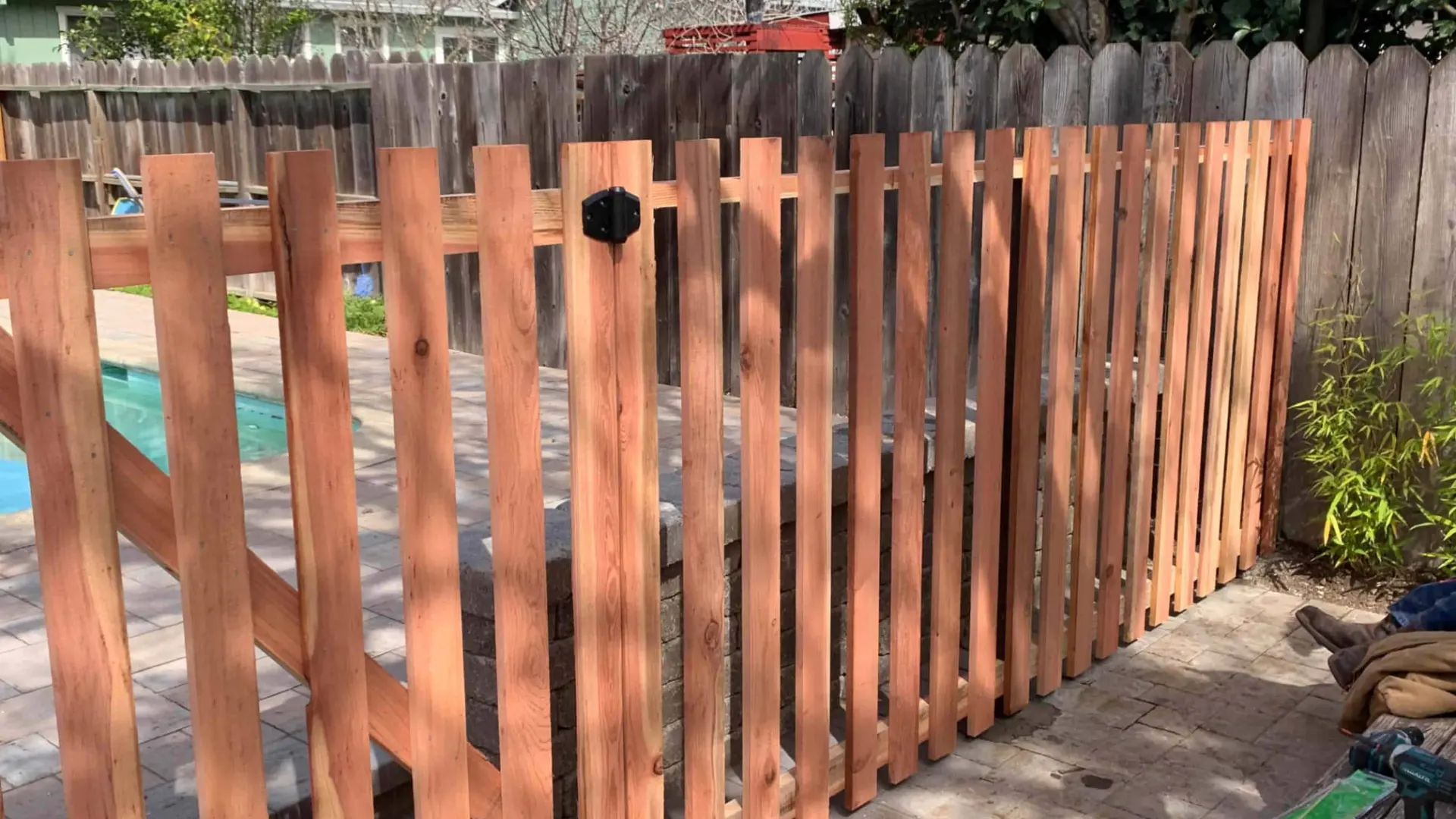 close up of picket fence with pool within the fence