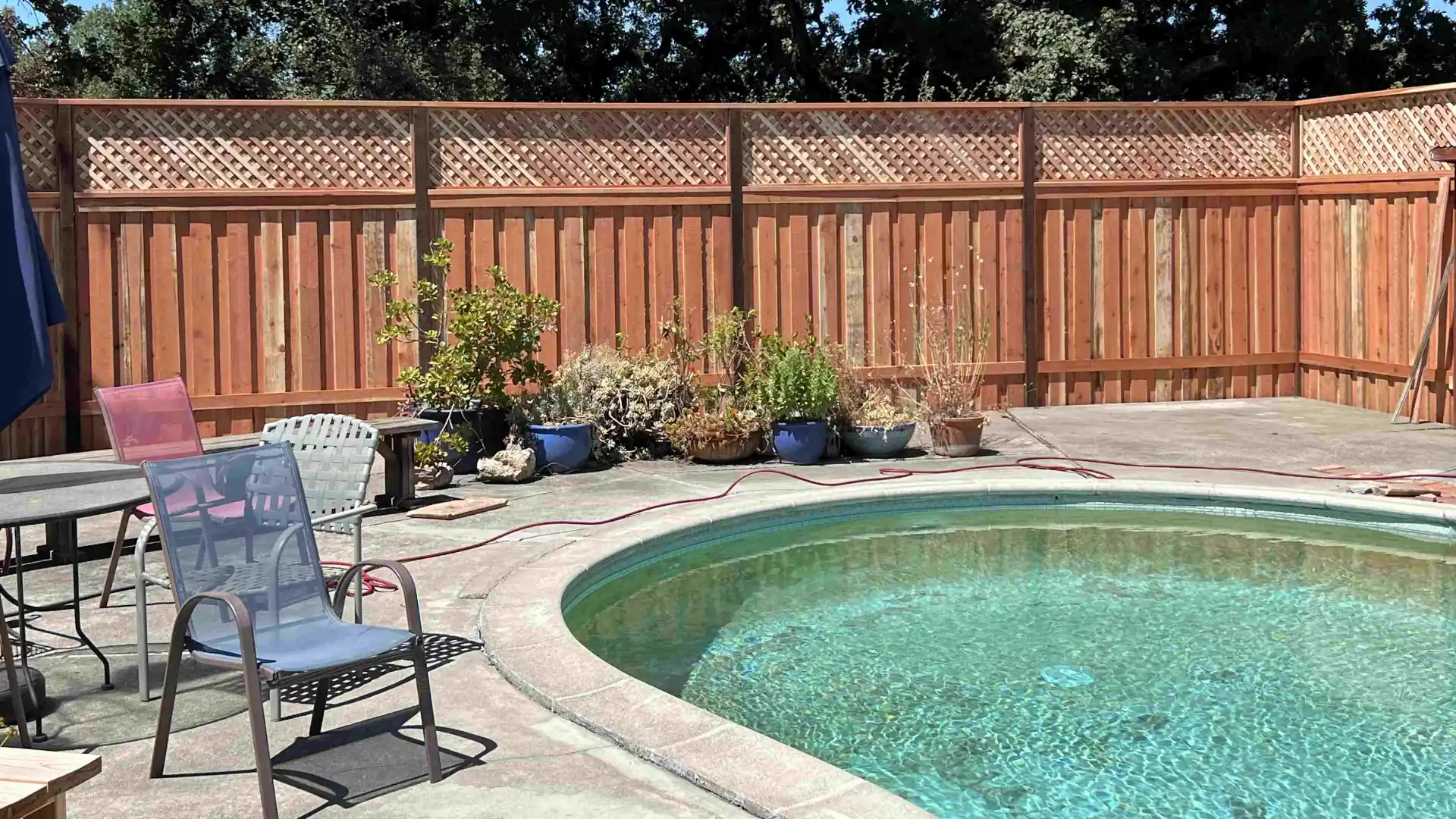 close up of picket fence with pool within the fence