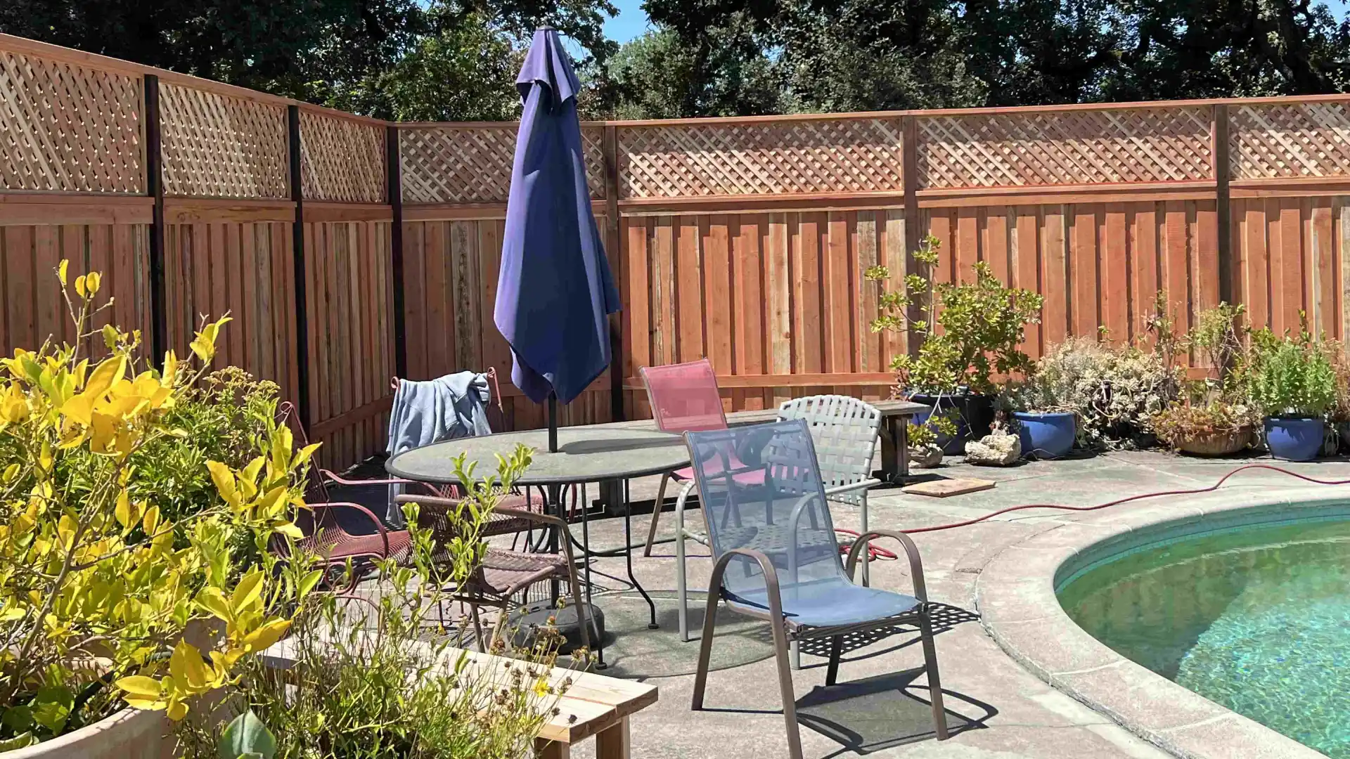 close up of picket fence with pool within the fence