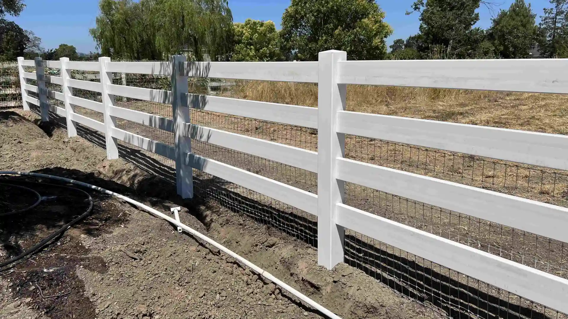 close up of picket fence with pool within the fence