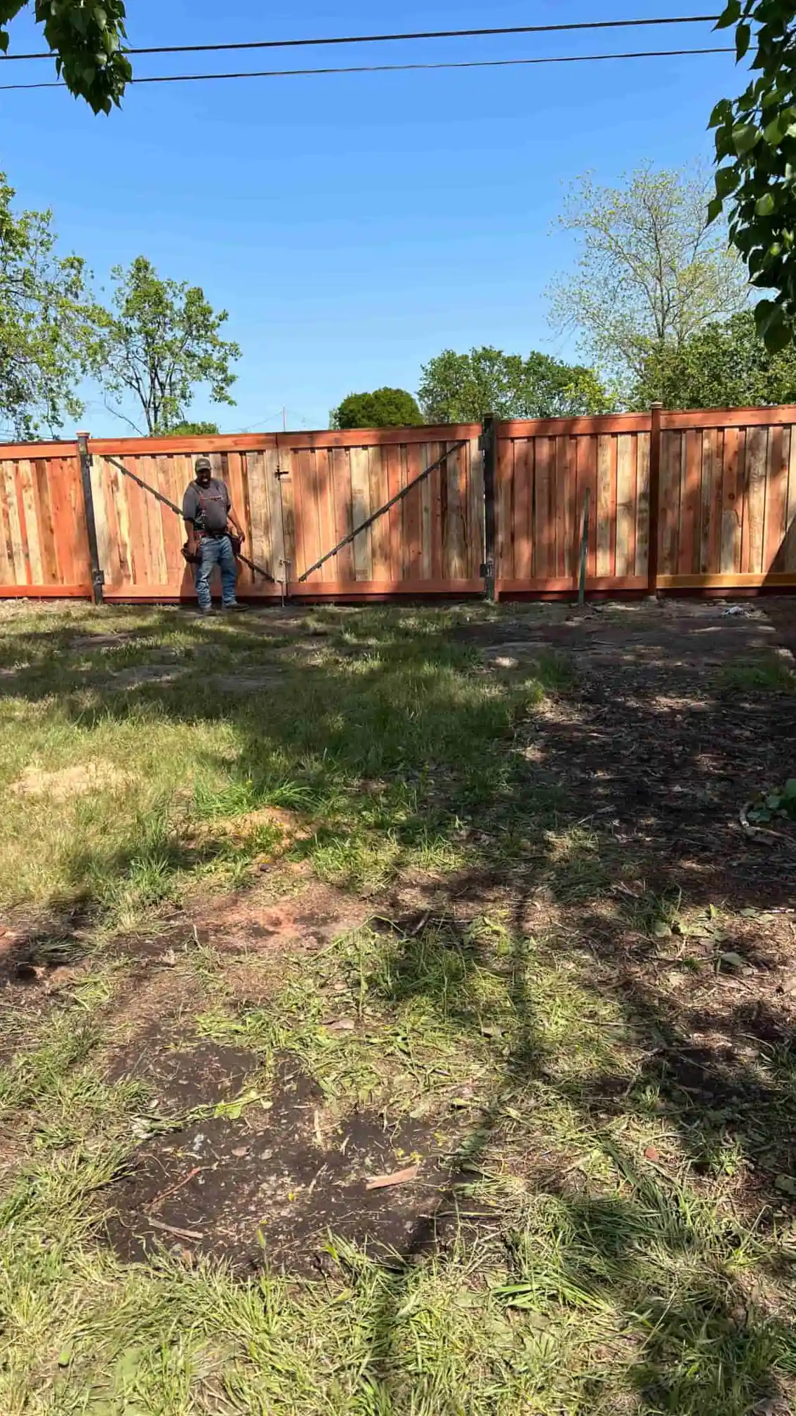 guy standing next to fence