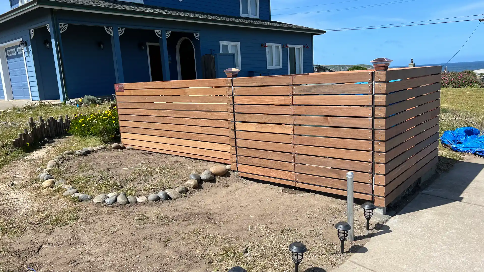 different angel of wooden fence blocking off outside gas container