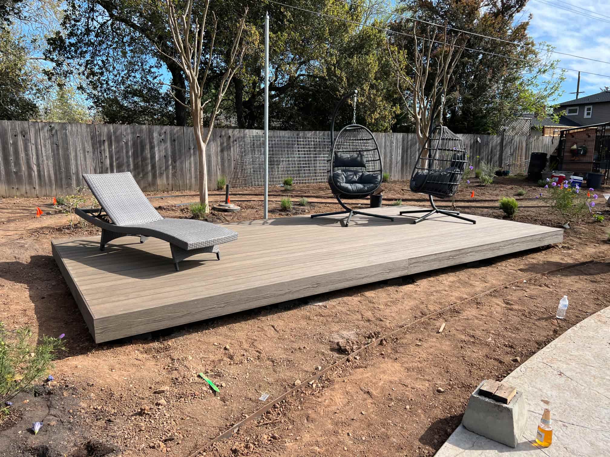 wooden deck with lawn chairs on top