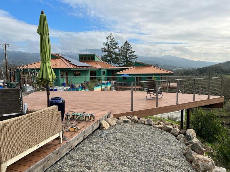 deck over a ledge with a metal gate